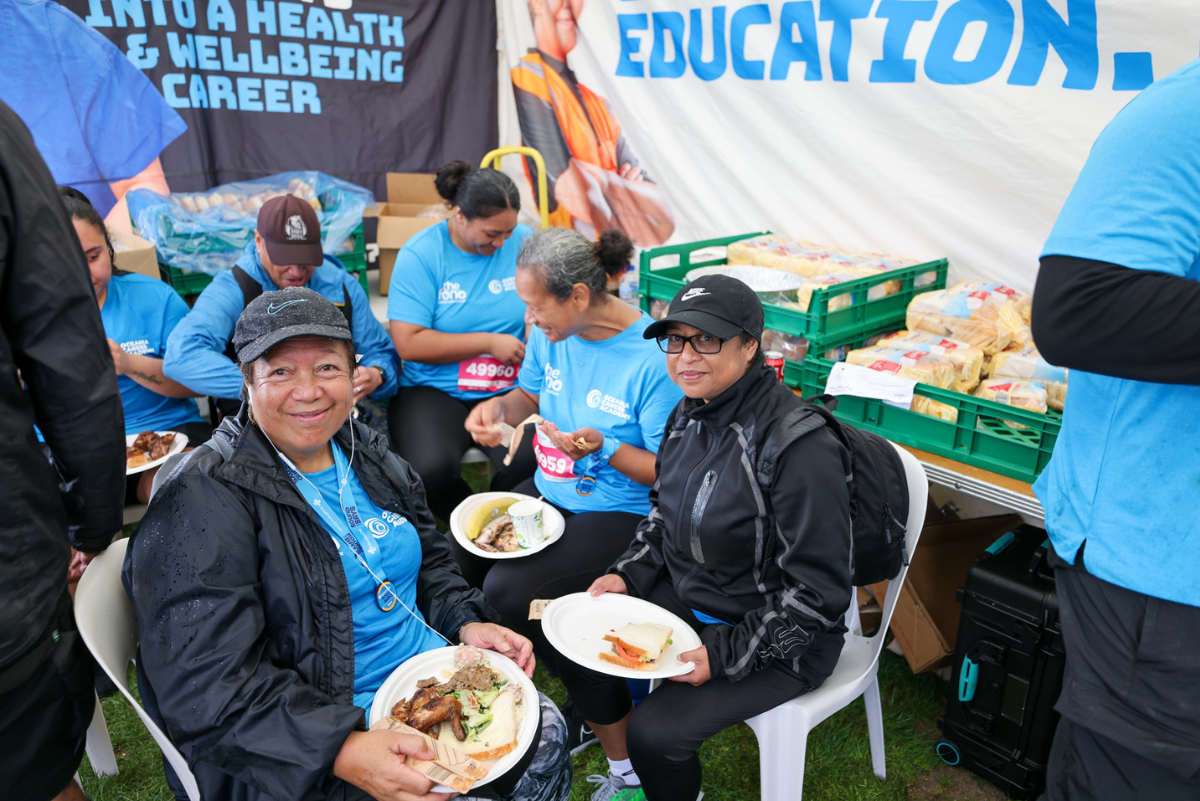 Women eat lunch at The Fono's tent at Round the Bays 2024