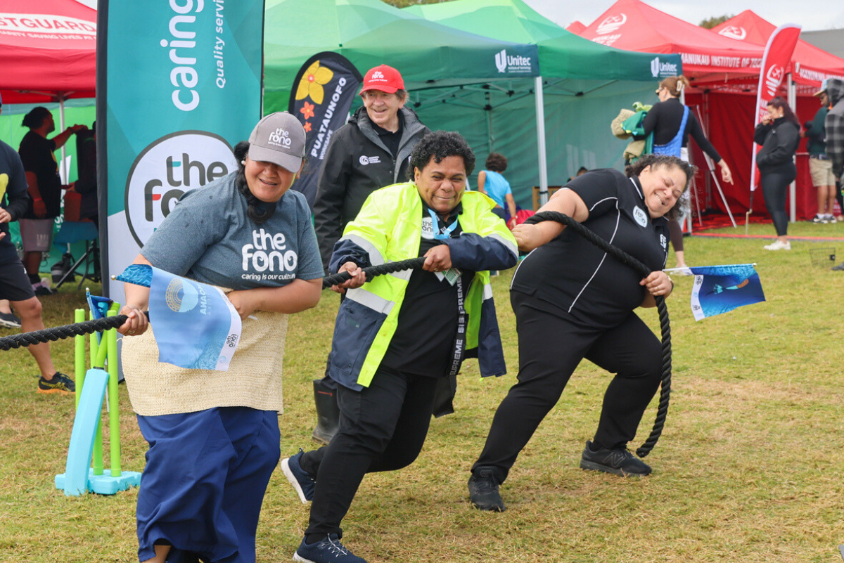 The Fono's staff doing tug of war at The Fono's stall, Polyfest 2024