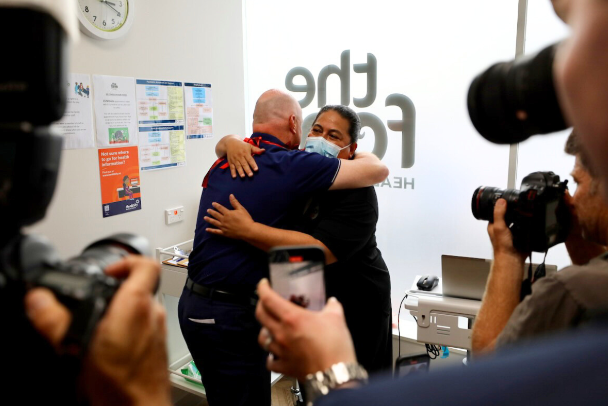 Prime Minister PM Christopher Luxon and Moana Manukia hug after he receives his flu immunisation at The Fono city healthcare centre